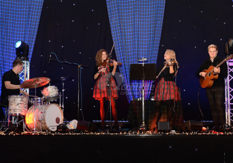 Scottish band on a stage at a Scottish themed company party