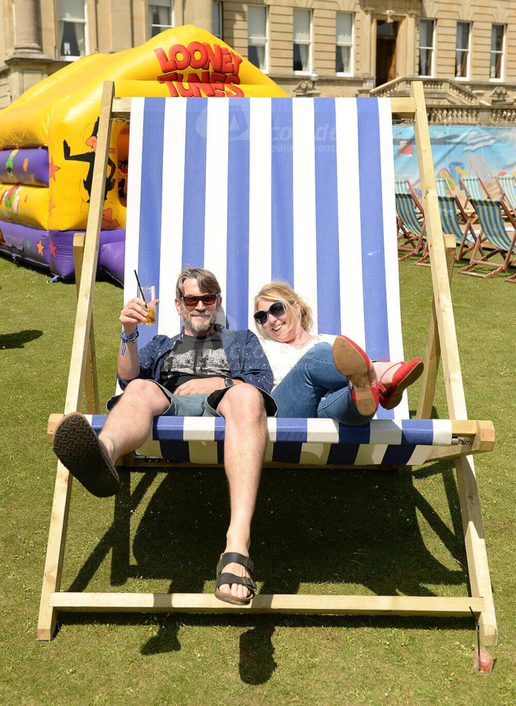 People sitting in giant deckchair at corporate fun day event