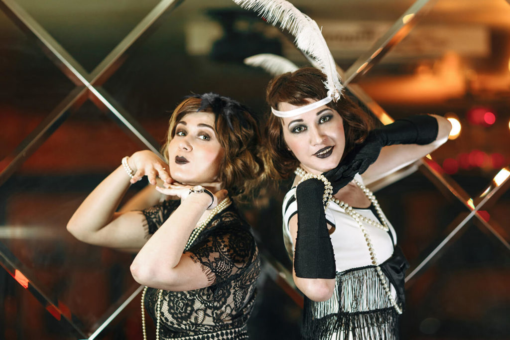 Two ladies at a Speakeasy themed company party