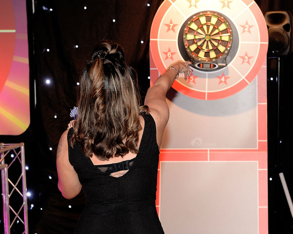 Lady throw dart at corporate event